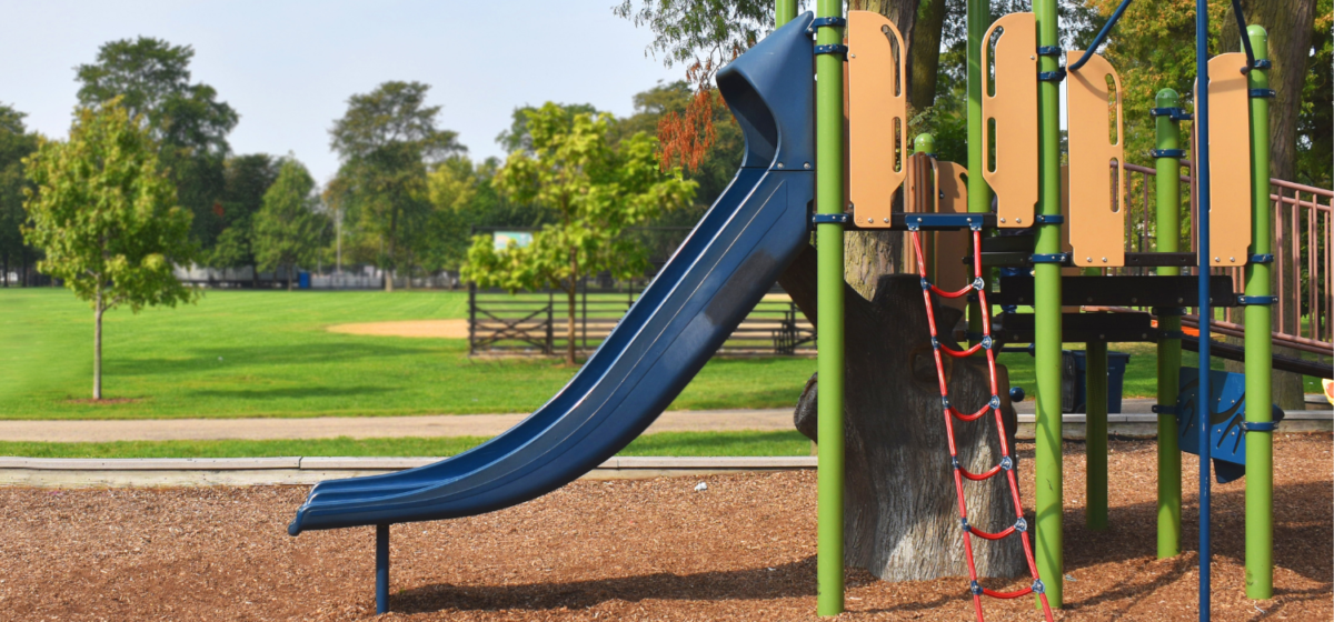 Public playground featuring a blue slide.